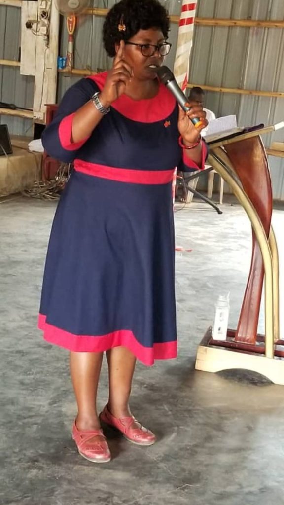 A woman preaching from the pulpit during a service