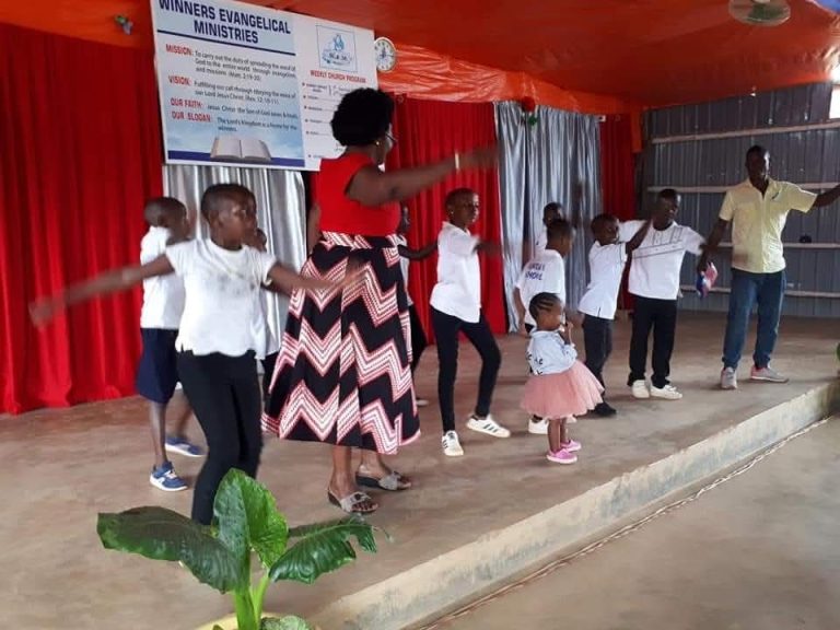 Children taking part in a church celebration outdoors
